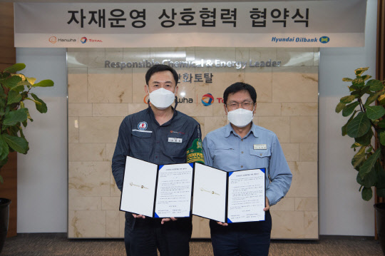 정해원(오른쪽) 현대오일뱅크 공장장과 김형준 한화토탈 공장장이 28일 충남 서산시 한화토탈 대산공장에서 '자재운영업무 상호협력을 위한 업무협약(MOU)'을 체결한 후 기념사진을 촬영하고 있다. <현대오일뱅크 제공>